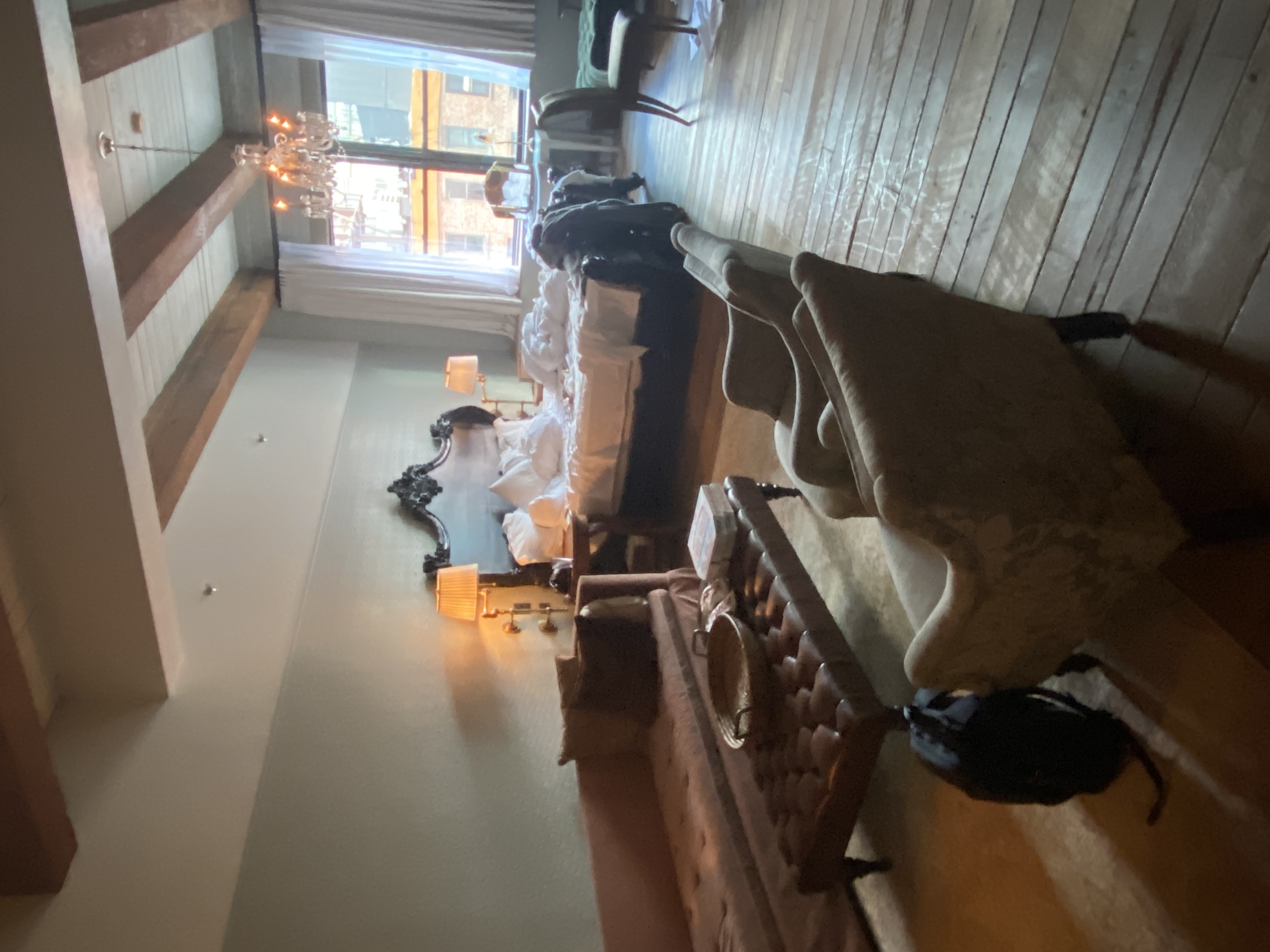 Heritage-style suite at Soho House Mumbai with exposed beams and chandelier